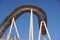 Detail of curved rollercoaster track at sunset
