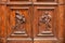 Detail of decorative carved panels on a beautiful timber door on the exterior of building