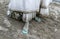 Detail of dirty white wedding dress and filthy foot covered by mud and dirt