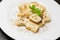 Detail of dish of italian swivels pasta with porcini mushrooms and sauce bechamel with pepper