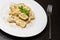 Detail of dish of italian swivels pasta with porcini mushrooms and sauce bechamel with pepper near fork