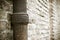 Detail of a downpipe against a brick wall - Tuscany - Italy