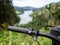 Detail of e-bike handlebar with speed button. Blurry landscape on background