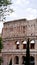 Detail of the facade with arches of the Colosseum (Amphitheatrum Flavium) with trees in front seen from Colle Oppio