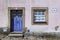 Detail of the facade of a colorful house in the historic village of Castelo Mendo with a door and window, in Portugal