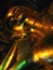 Detail of a face of a shiny religious Reclining buddha statue in Bangkok, Thailand