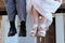 Detail of the feet of the groom and the bride sitting on a scaffolding