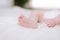 detail of the feet of a newborn in studio lighting against white