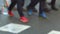 Detail of feet passing through a pedestrian crossing. Slow Motion