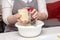 Detail of female hands grate cheese. Women prepare cheese in the kitchen for pizza or pie. Baking concept