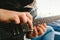 Detail of the fingers of a guitarist placed on the fret of the mast of the guitar playing a chord doing Tapping