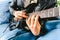 Detail of the fingers of a guitarist placed on the fret of the mast of the guitar playing a chord doing Tapping