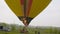 Detail of flying colorful cloud hopper hot air balloon inflated with fire flame 4K