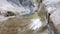 Detail focused in the foreground of a stream of transparent waters in high mountains.