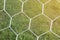 Detail of football net with sunlight in the field