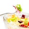 Detail of fork on italian fresh salad on white