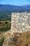 Detail of the fortification walls of Mycenae against the backdrop of the surrounding countryside