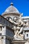 Detail of the Fountain Putti Fountain and the Duomo Santa Maria Assunta at Piazza dei Miracoli square in Pisa, Tuscany, Italy