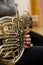 Detail French Horn in the hands of a musician