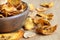 Detail of fried carrot and parsnip chips in rustic wood bowl.