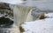 Detail of frozen Jagala waterfall with icicles hanging from rocks, view from above, Estonia