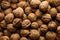 Detail full frame high angle view of pile of walnuts lying in box