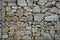 Detail of a gabion wall, stones straightened into a pre-built wire basket. serves as a design element in architecture, or as a pur