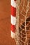 Detail of gate frame . Outdoor football or handball playground, light red clay