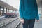 Detail of a girl posing in a railroad station