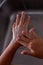 Detail of a girl`s soapy hands. Washing her hands in the kitchen sink. Vertical photograph