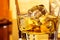 Detail of glass of whiskey with ices near bottle on table with reflection, warm atmosphere