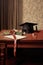 detail of a graduation cap and diploma on a table