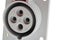 Detail of gray plastic three phase electric wall plug, white background