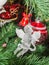 Detail of green Christmas (Chrismas) tree with colored ornaments, globes, stars, Santa Claus, Snowman