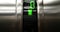Detail of green led number of elevator that go up from first to zero floor, business and