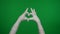 Detail green screen isolated chroma key photo capturing mummy& x27;s hands raised up in the air, making a heart with its