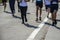 Detail of a group of runners during a city marathon. Legs and sneakers. Muscles under stress