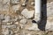 Detail of a gutter and a stone wall from a country house in Cat