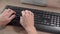 Detail on a hand controlling a computer using a keyboard and a mouse