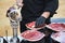Detail of the hand of a professional Iberian ham cutter placing the slices on a plate. Concept pork, food, ham, iberian, spain,