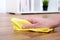 Detail of a hand with sponge cleaning parquet floor