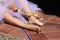 Detail of hands of a ballet dancer putting on and fastening her pink ballet shoes. Concept dance and classical ballet