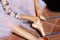 Detail of hands of a ballet dancer putting on and fastening her pink ballet shoes. Concept dance and classical ballet