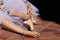 Detail of hands of a ballet dancer putting on and fastening her pink ballet shoes. Concept dance and classical ballet