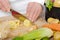 Detail of hands of chef slicing potatoes