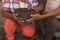 Detail of the hands of a stone laborer to make molcajetes, giving it to the female hands of an elderly Mexican woman.