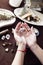 Detail of the hands of a woman with a crystal ball on a witch altar