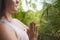 Detail of hands of young attractive and happy relaxed woman practicing yoga position doing meditation and concentration outdoors