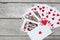 Detail of heart deck poker playing cars on wooden table