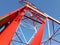 Detail of high voltage towers painted red on top of a mountain